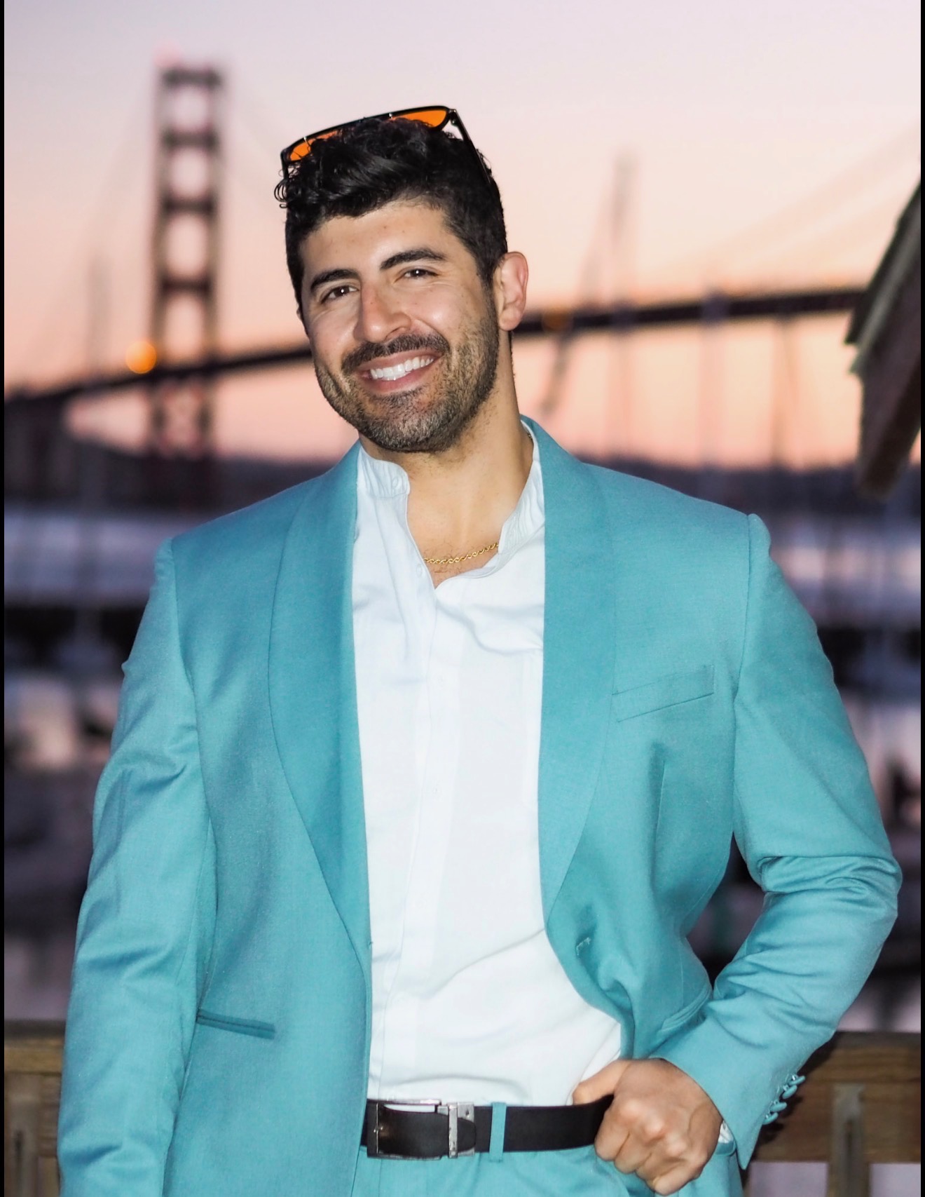Spotlight founder in a turquoise suit in front of the Bay Bridge